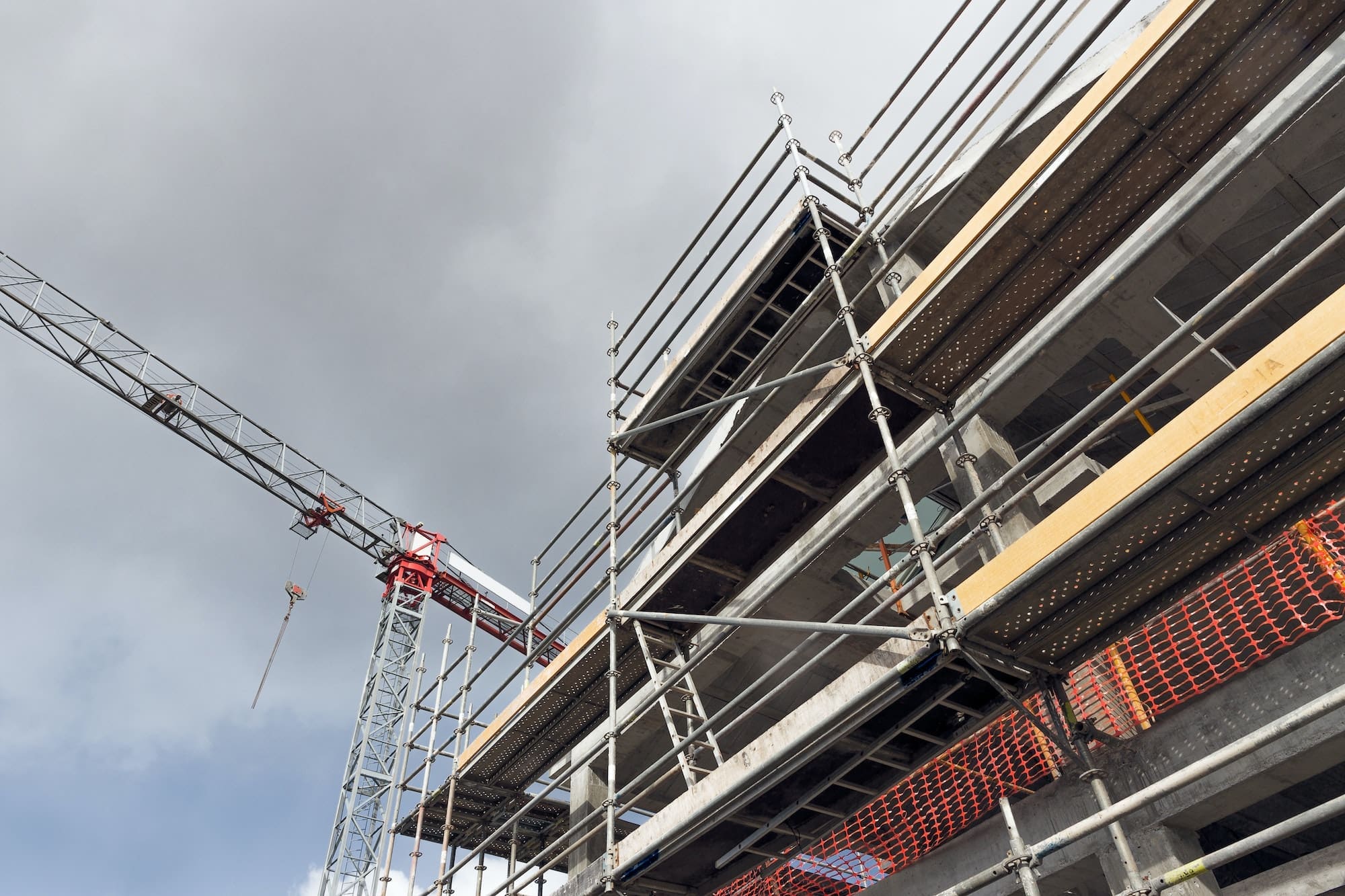 Building construction site with crane and scaffolds