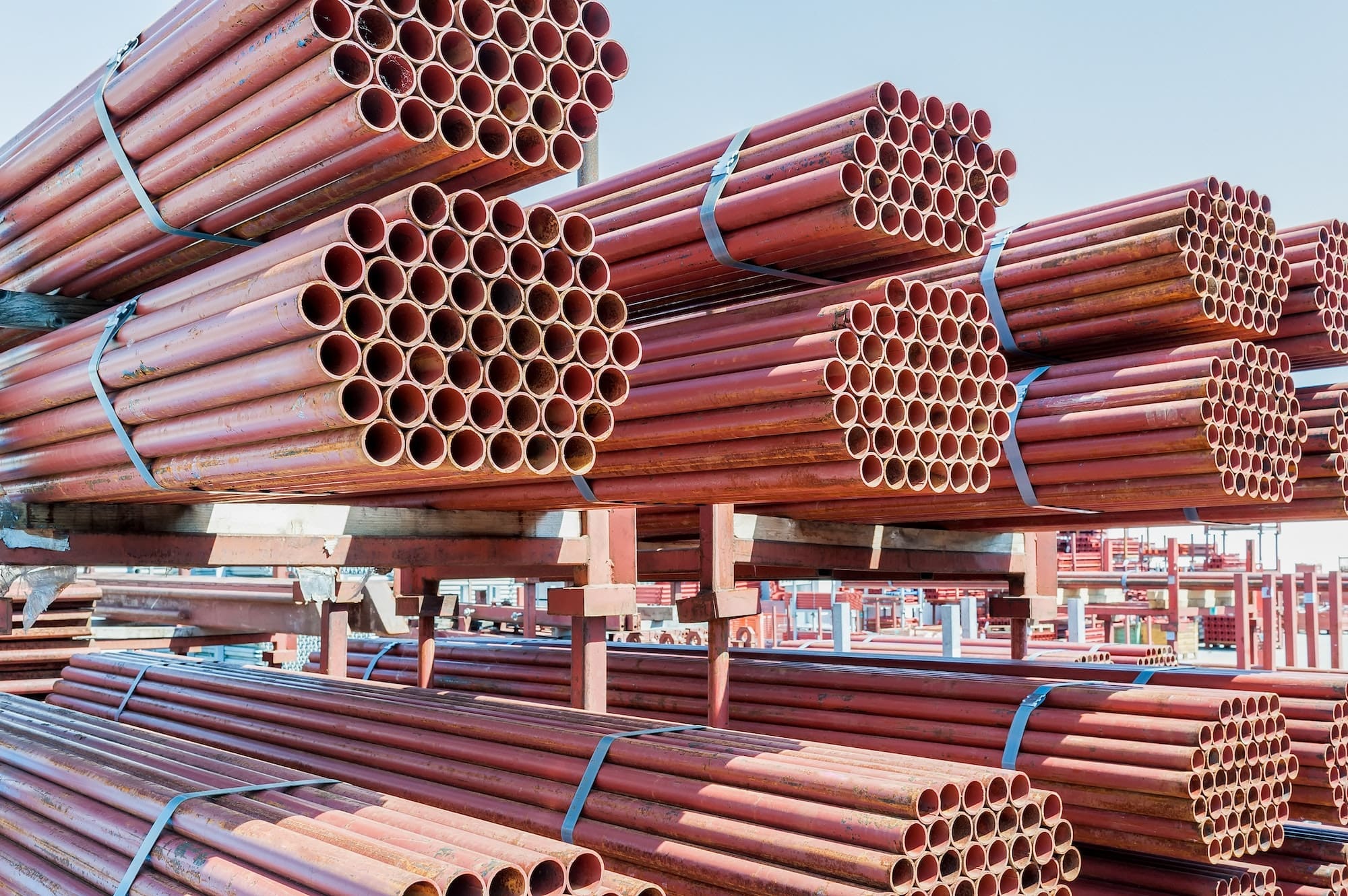 Stack of steel pipes for scaffolding in stock.